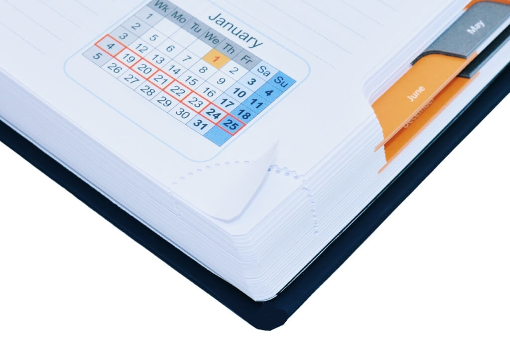Close-up of HGV Drivers Diary pages showing tear-off perforated page corners and monthly tab dividers