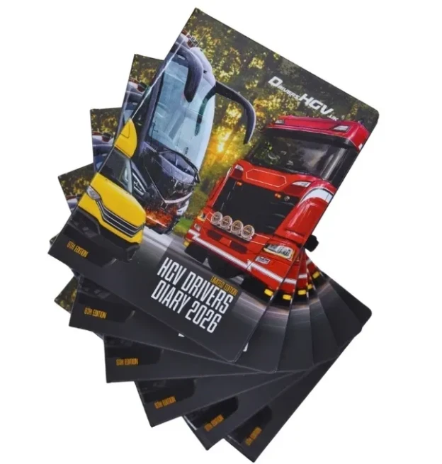 Fanned-out stack of HGV Drivers Diary 2026 hardcovers featuring a lorry and coach design