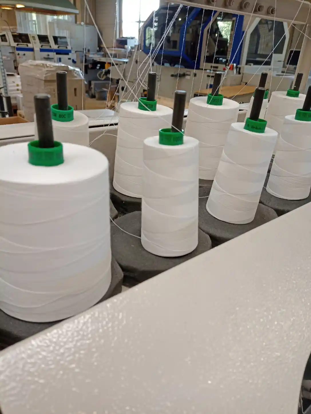 White binding thread spools used during the sewing stage of HGV Drivers Diary production.